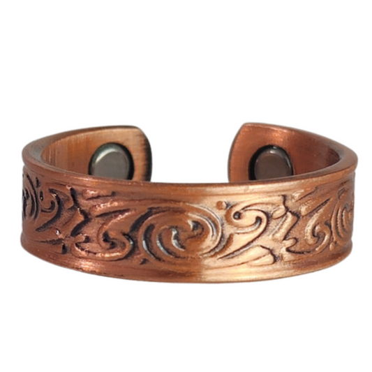 Feverfew copper ring by Magnetic Mobility featuring an intricate Irish design. This adjustable ring is designed to be easily worn on arthritic fingers, providing both style and functionality.