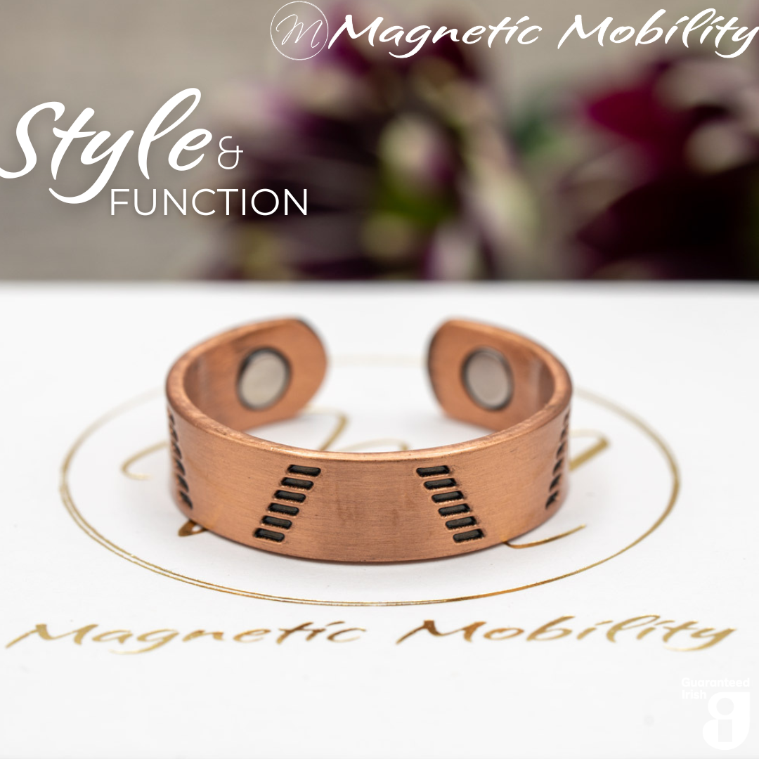 Soloman copper ring by Magnetic Mobility featuring a modern design. Ring is shown on top of a white branded gift box. This adjustable ring is designed to be easily worn on arthritic fingers, providing both style and functionality.